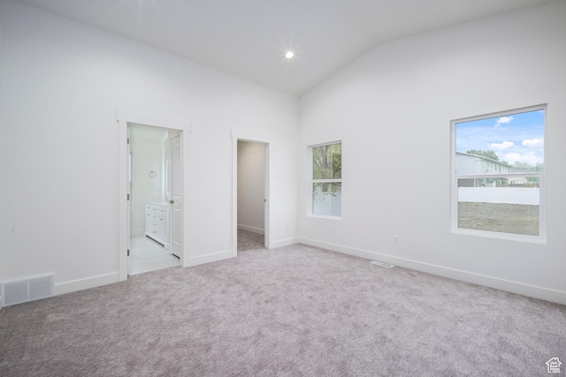 92 N 300 W, American Fork, UT 84003 - unfurnished bedroom with light colored carpet, a walk in closet, high vaulted ceiling, baseboards, and connected bathroom
