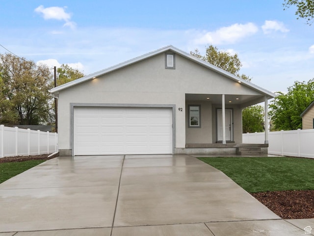 92 N 300 W, American Fork, UT 84003 - view of front facade featuring stucco siding, concrete driveway, a garage, and covered porch