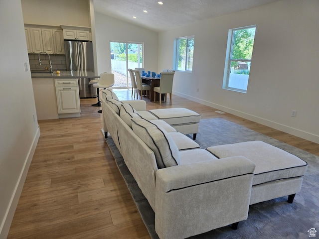 92 N 300 W, American Fork, UT 84003 - living area with lofted ceiling, baseboards, light wood-type flooring, and recessed lighting