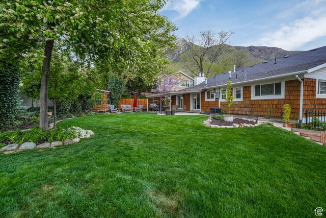 3273 E Bernada Dr, Salt Lake City, UT 84124 - rear view of property with a yard, cooling unit, a mountain view, and a patio area