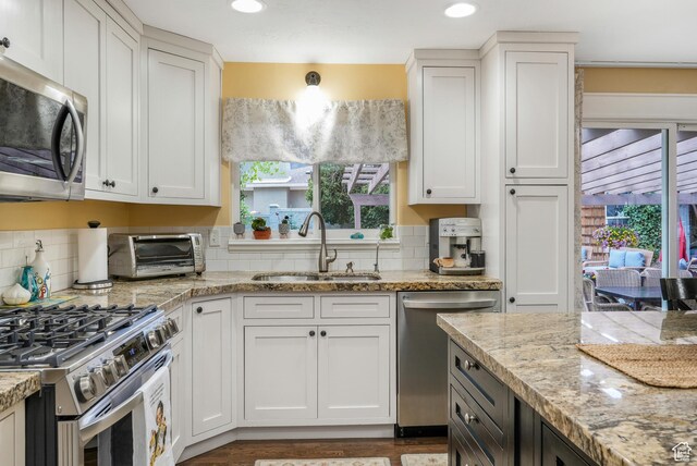 3273 E Bernada Dr, Salt Lake City, UT 84124 - kitchen with a sink, a toaster, white cabinets, and stainless steel appliances