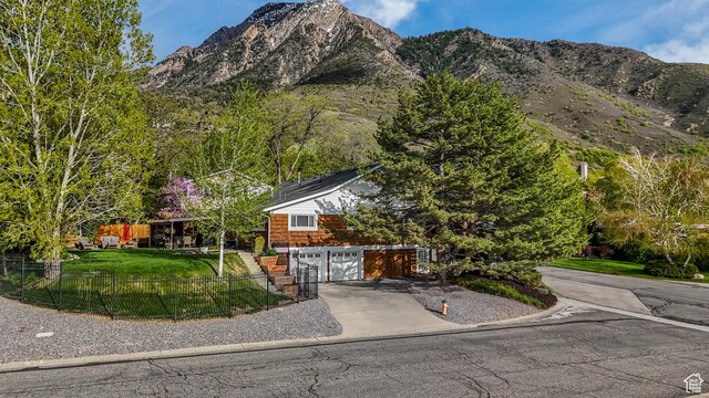 3273 E Bernada Dr, Salt Lake City, UT 84124 - view of front of home with a garage, a mountain view, concrete driveway, and fence private yard