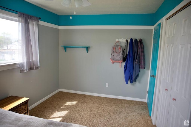 unfurnished bedroom with baseboards and carpet flooring