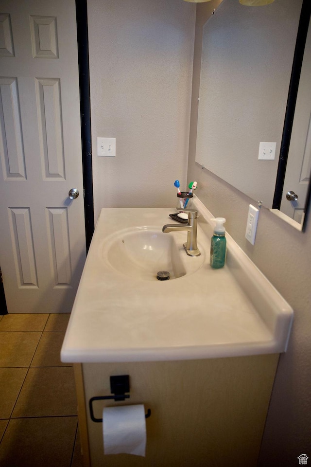 bathroom featuring tile patterned flooring and vanity