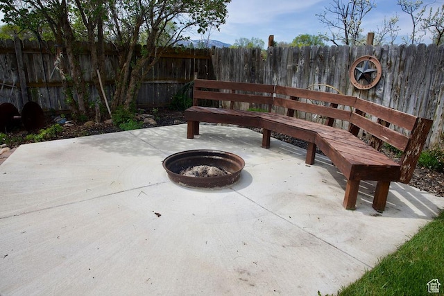 view of patio / terrace featuring fence and an outdoor fire pit