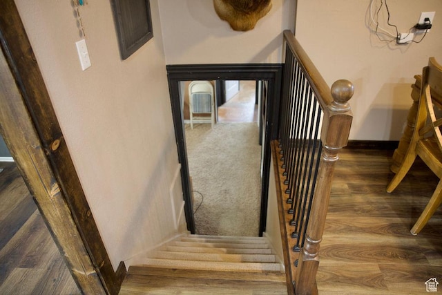 stairs featuring baseboards and wood finished floors