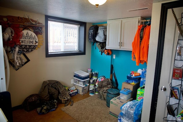 laundry area featuring a textured ceiling and visible vents