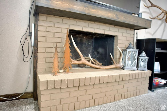 details featuring carpet flooring and a brick fireplace