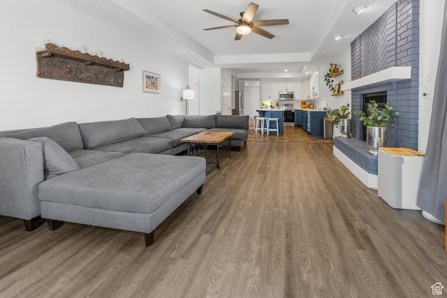 531 E Valley Dr, Heber City, UT 84032 - living area with a ceiling fan, wood finished floors, a tray ceiling, and a fireplace