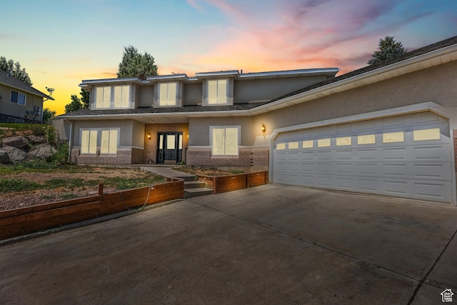 531 E Valley Dr, Heber City, UT 84032 - view of front of house featuring stucco siding, french doors, brick siding, concrete driveway, and an attached garage