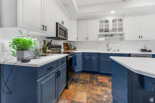 531 E Valley Dr, Heber City, UT 84032 - kitchen featuring stone tile flooring, a sink, light countertops, blue cabinets, and stainless steel appliances