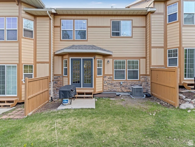 14768 S Deer Park Ln E, Draper Ut Cnty, UT 84020 - rear view of house featuring entry steps, central air condition unit, fence, a yard, and stone siding