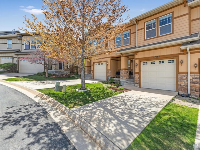 14768 S Deer Park Ln E, Draper Ut Cnty, UT 84020 - view of property with an attached garage, driveway, and stone siding
