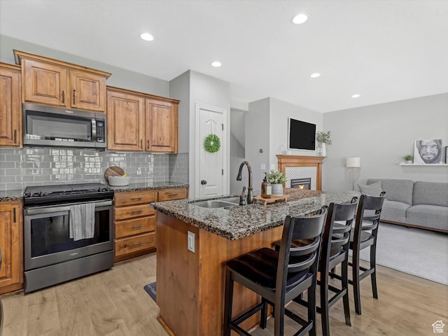 14768 S Deer Park Ln E, Draper Ut Cnty, UT 84020 - kitchen with a sink, stainless steel appliances, light wood-style flooring, and open floor plan