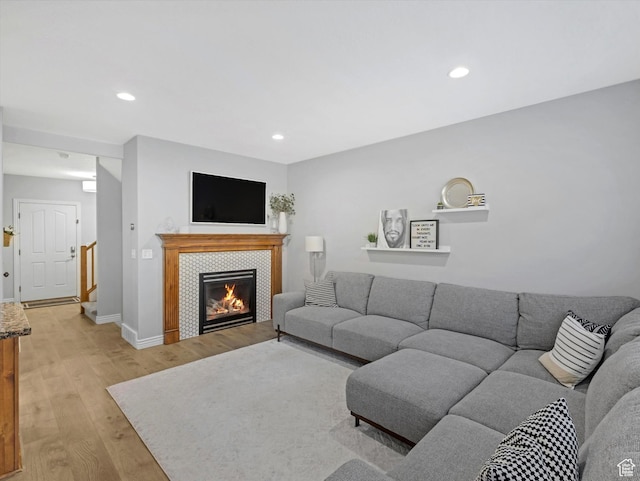 14768 S Deer Park Ln E, Draper Ut Cnty, UT 84020 - living room featuring light wood-style floors, recessed lighting, and a tiled fireplace