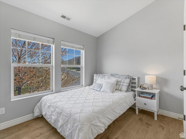 14768 S Deer Park Ln E, Draper Ut Cnty, UT 84020 - bedroom featuring baseboards, lofted ceiling, wood finished floors, and visible vents