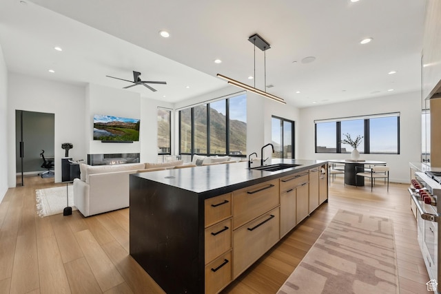 3944 W Oak Hill Dr, Alpine, UT 84004 - kitchen with double oven range, dark countertops, modern cabinets, a sink, and light brown cabinets
