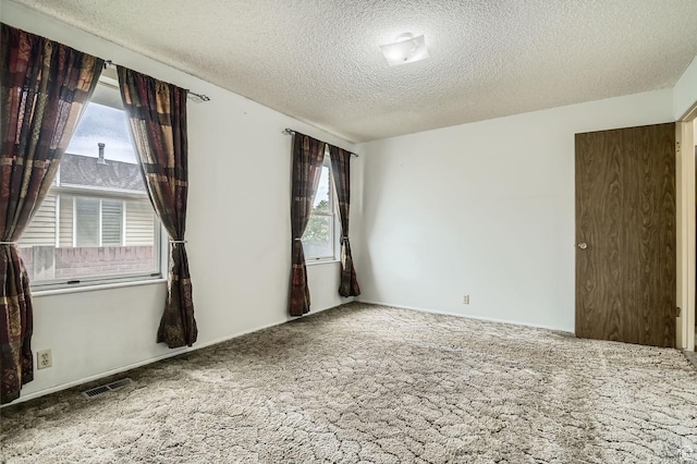 4758 S Mocha Dr W, Taylorsville, UT 84129 - unfurnished room with visible vents, carpet flooring, a textured ceiling, and a wealth of natural light