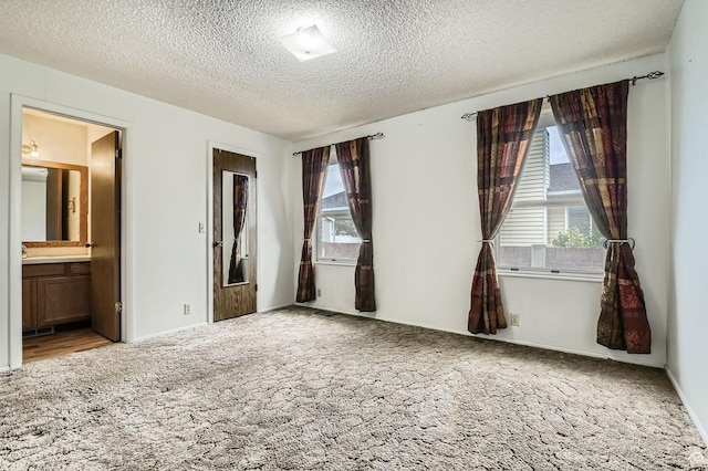 4758 S Mocha Dr W, Taylorsville, UT 84129 - unfurnished bedroom with carpet floors, a textured ceiling, and ensuite bath
