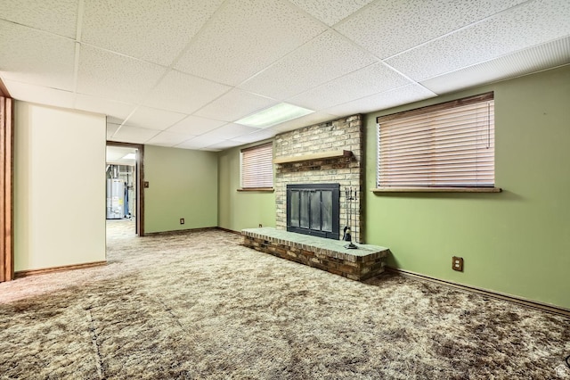 4758 S Mocha Dr W, Taylorsville, UT 84129 - unfurnished living room featuring carpet flooring, baseboards, a paneled ceiling, and water heater
