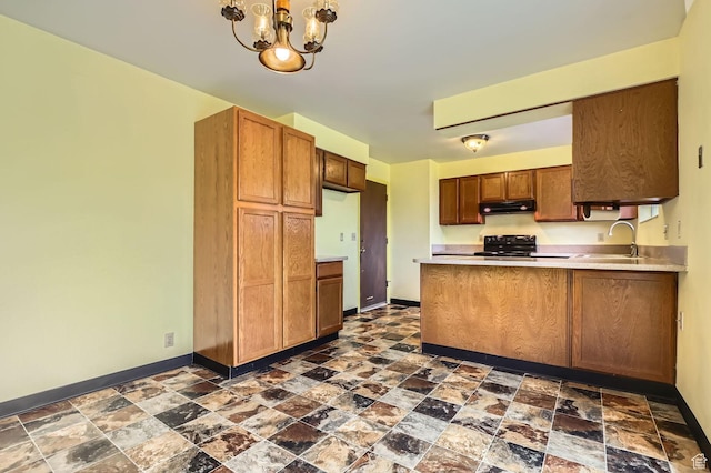 4758 S Mocha Dr W, Taylorsville, UT 84129 - kitchen with black / electric stove, stone finish flooring, a sink, baseboards, and under cabinet range hood