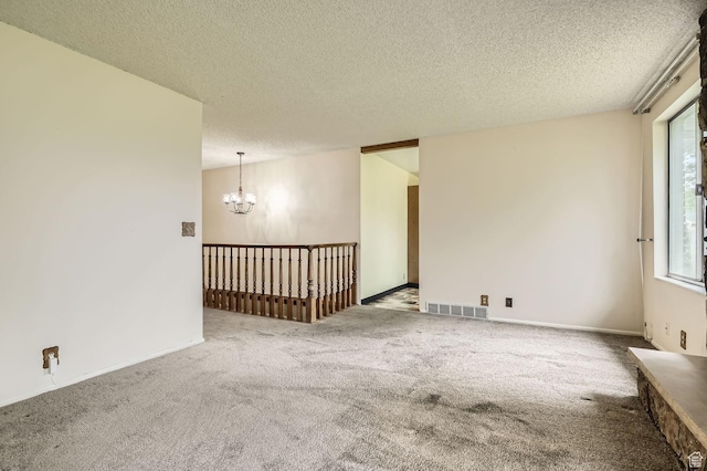 4758 S Mocha Dr W, Taylorsville, UT 84129 - spare room featuring carpet floors, a textured ceiling, a chandelier, and visible vents
