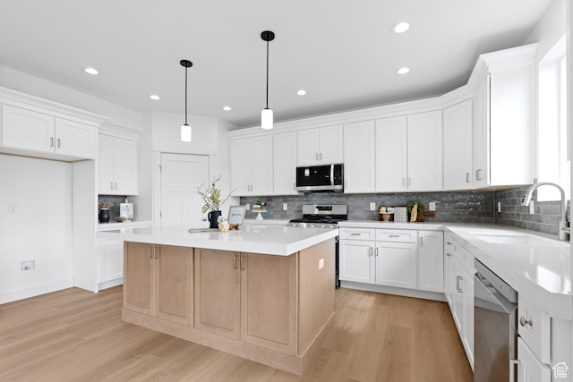 544 N 350 W Unit 7R, Morgan, UT 84050 - kitchen with stainless steel appliances, a sink, light wood finished floors, a kitchen island, and recessed lighting