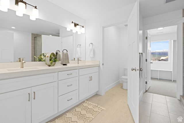 544 N 350 W Unit 7R, Morgan, UT 84050 - bathroom featuring toilet, double vanity, a shower with door, tile patterned floors, and recessed lighting