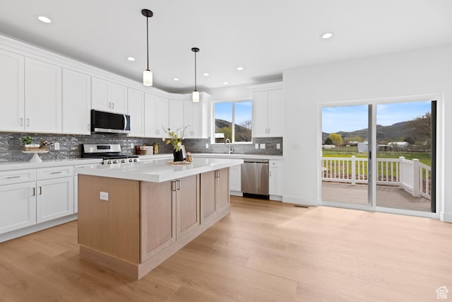 544 N 350 W Unit 7R, Morgan, UT 84050 - kitchen featuring appliances with stainless steel finishes, tasteful backsplash, light wood-style floors, white cabinetry, and recessed lighting