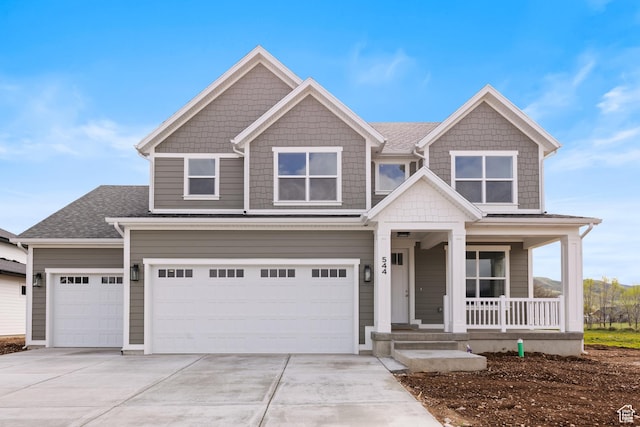 544 N 350 W Unit 7R, Morgan, UT 84050 - view of front facade with covered porch, driveway, a garage, and a shingled roof