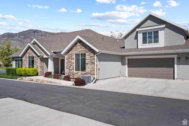 view of front of property with a mountain view, stucco siding, and stone siding