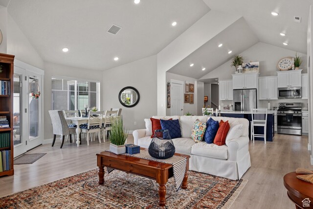 living area featuring recessed lighting, visible vents, and light wood-style floors