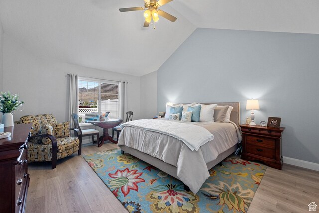 bedroom featuring baseboards, a ceiling fan, vaulted ceiling, and wood finished floors