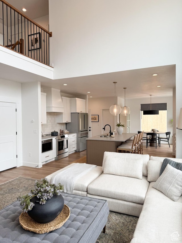 7648 S Iron Cyn Unit 341, West Jordan, UT 84081 - living area with recessed lighting, a towering ceiling, and wood finished floors
