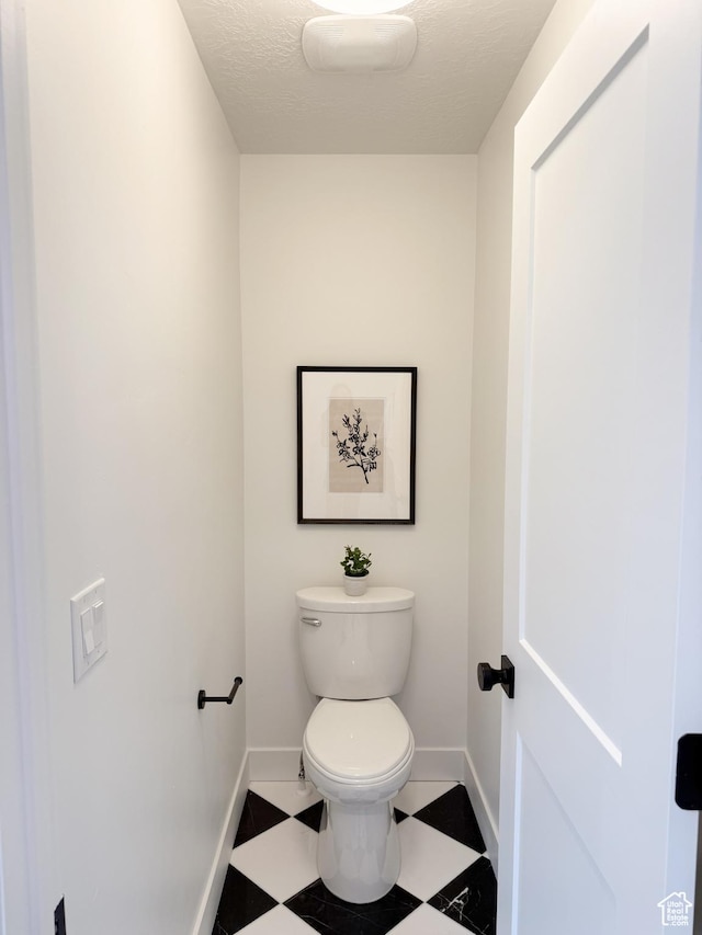 7648 S Iron Cyn Unit 341, West Jordan, UT 84081 - bathroom featuring baseboards, tile patterned floors, and toilet