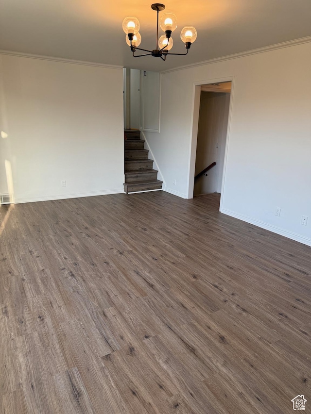interior space featuring crown molding, dark wood-style flooring, an inviting chandelier, and stairs