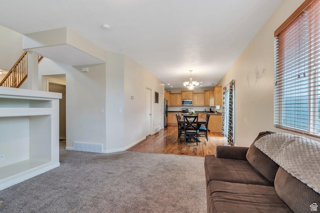 7812 N Crestwood Cir, Eagle Mountain, UT 84005 - carpeted living area featuring a chandelier, baseboards, and stairs