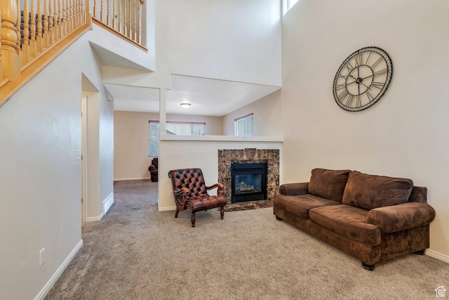 7812 N Crestwood Cir, Eagle Mountain, UT 84005 - living area with a high end fireplace, carpet floors, baseboards, a towering ceiling, and stairway
