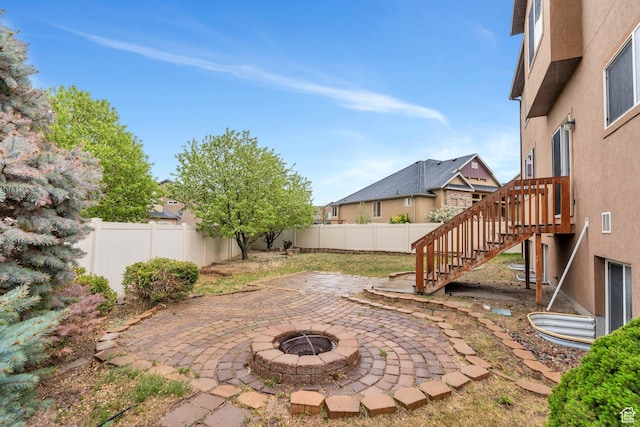 7812 N Crestwood Cir, Eagle Mountain, UT 84005 - fenced backyard featuring a patio, a fire pit, and stairs