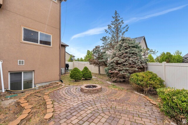 7812 N Crestwood Cir, Eagle Mountain, UT 84005 - fenced backyard featuring an outdoor fire pit and a patio
