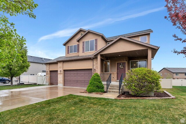 7812 N Crestwood Cir, Eagle Mountain, UT 84005 - view of front of home with stucco siding, a garage, driveway, covered porch, and brick siding