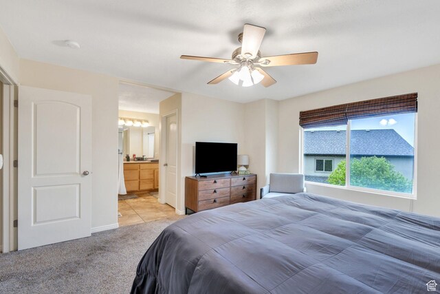 7812 N Crestwood Cir, Eagle Mountain, UT 84005 - bedroom with light colored carpet, ceiling fan, baseboards, and ensuite bathroom
