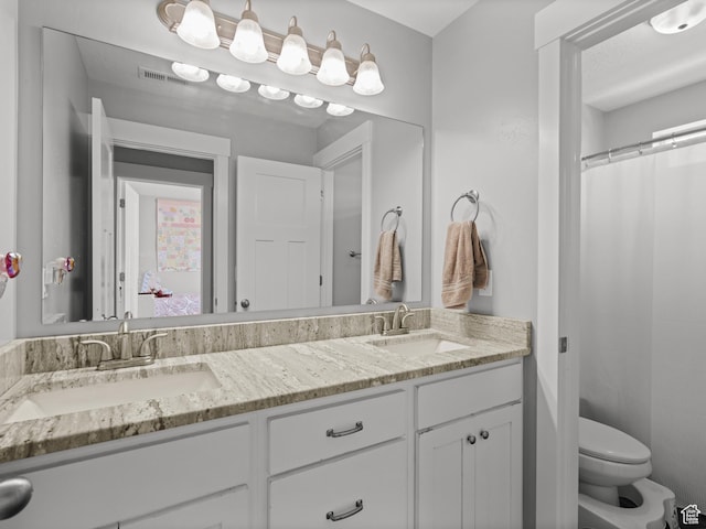 1227 W 20 S, Pleasant Grove, UT 84062 - bathroom featuring double vanity, toilet, visible vents, and a sink