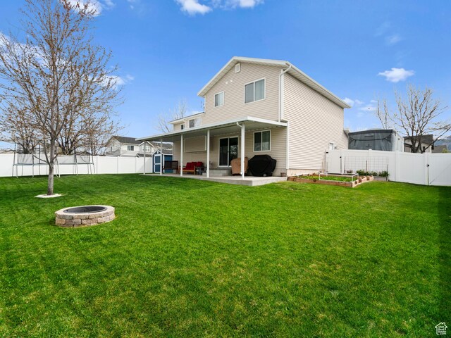 709 S 1500 W, Logan, UT 84321 - back of property with a gate, a fenced backyard, an outdoor fire pit, a yard, and a patio