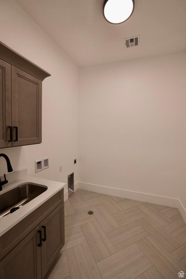 3842 S Kennedy Ln Unit 124, Washington, UT 84780 - clothes washing area featuring washer hookup, electric dryer hookup, visible vents, cabinet space, and a sink