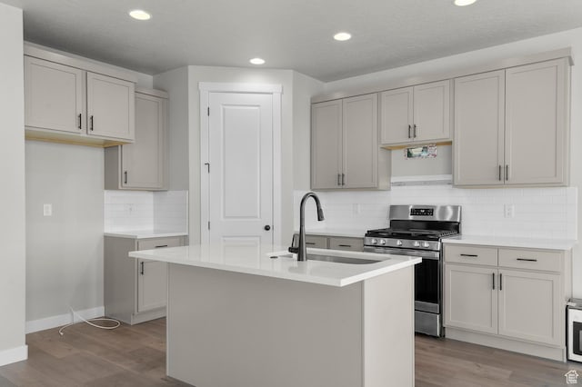 6636 W Spring Snow Ln, Herriman, UT 84096 - kitchen featuring stainless steel gas stove, wood finished floors, decorative backsplash, recessed lighting, and light countertops