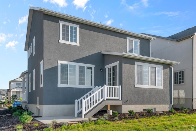 6636 W Spring Snow Ln, Herriman, UT 84096 - back of property featuring stucco siding and a patio