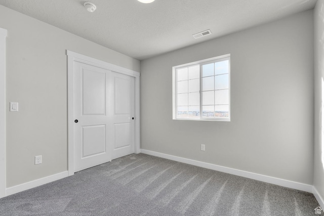 6636 W Spring Snow Ln, Herriman, UT 84096 - unfurnished bedroom featuring carpet, a closet, and a textured ceiling