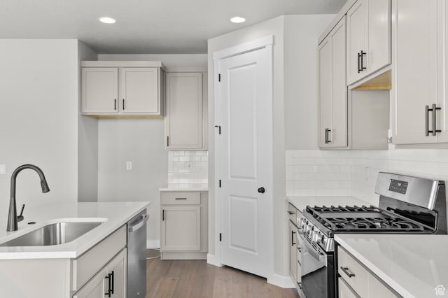 6636 W Spring Snow Ln, Herriman, UT 84096 - kitchen featuring stainless steel appliances, light wood-type flooring, light countertops, tasteful backsplash, and recessed lighting