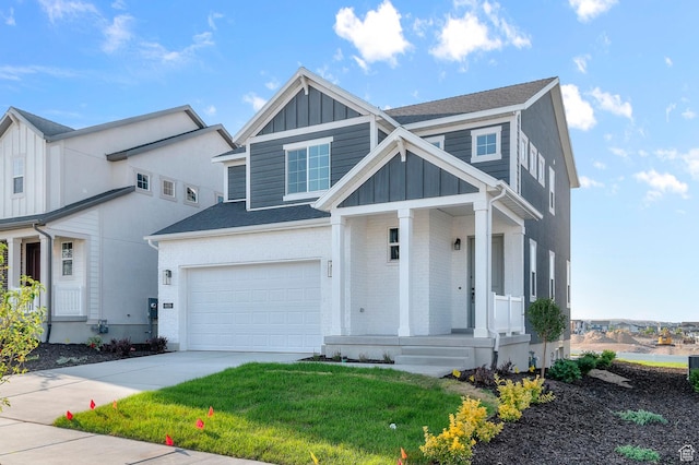 6636 W Spring Snow Ln, Herriman, UT 84096 - view of front of property featuring board and batten siding, a porch, a garage, driveway, and a front lawn